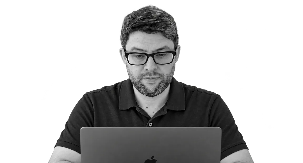David working behind a laptop.